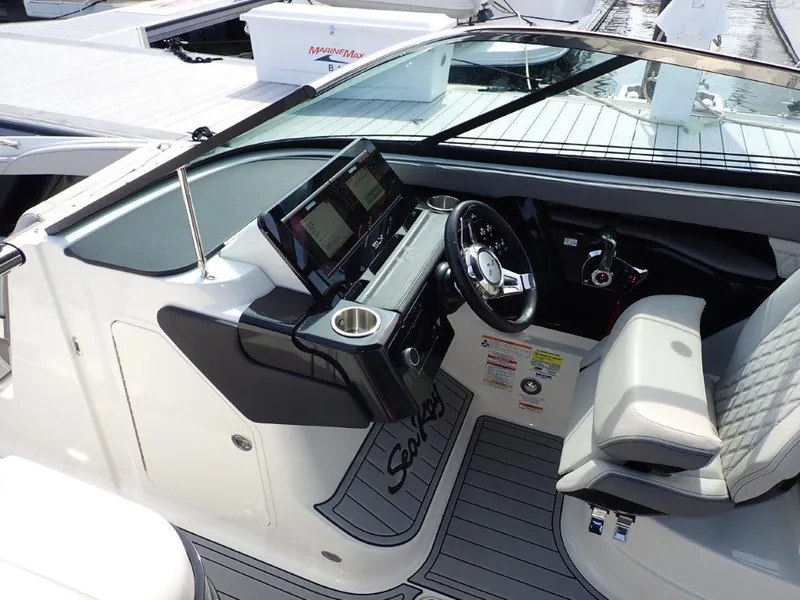 Slide: The Image of 2024 Sea Ray SLX 260 Outboard helm with modern controls and luxurious seating. - 16