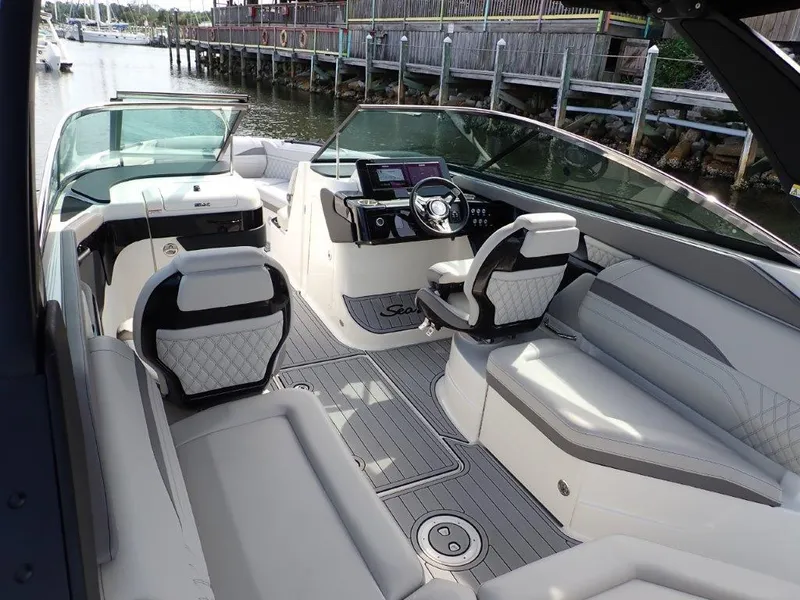 Slide: The Image of 2024 Sea Ray SLX 260 Outboard boat interior with luxurious seating and modern dashboard. - 20