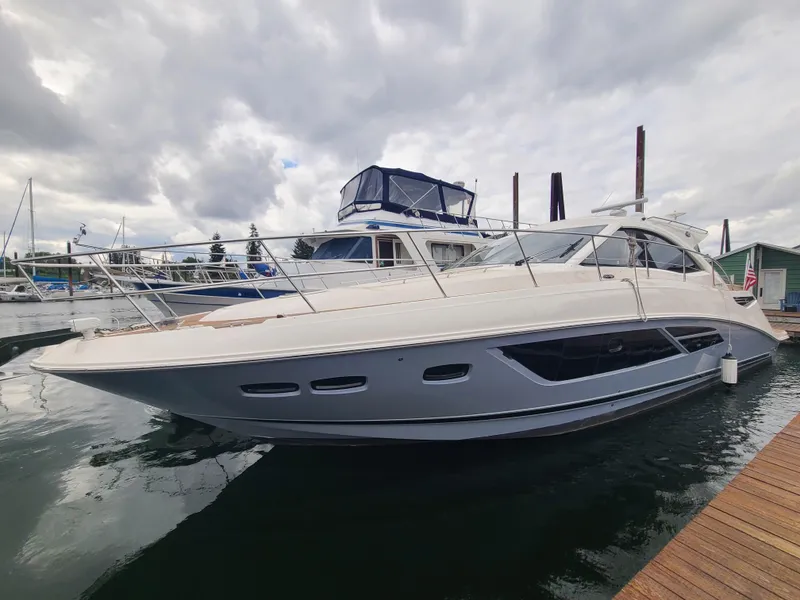 The Image of 2014 Sea Ray 510 Sundancer yacht docked at marina under cloudy sky. - 0