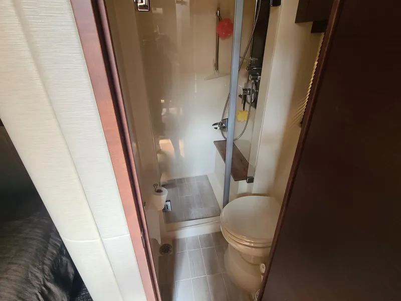 Slide: The Image of Bathroom interior of 2014 Sea Ray 510 Sundancer yacht, featuring shower and toilet. - 14