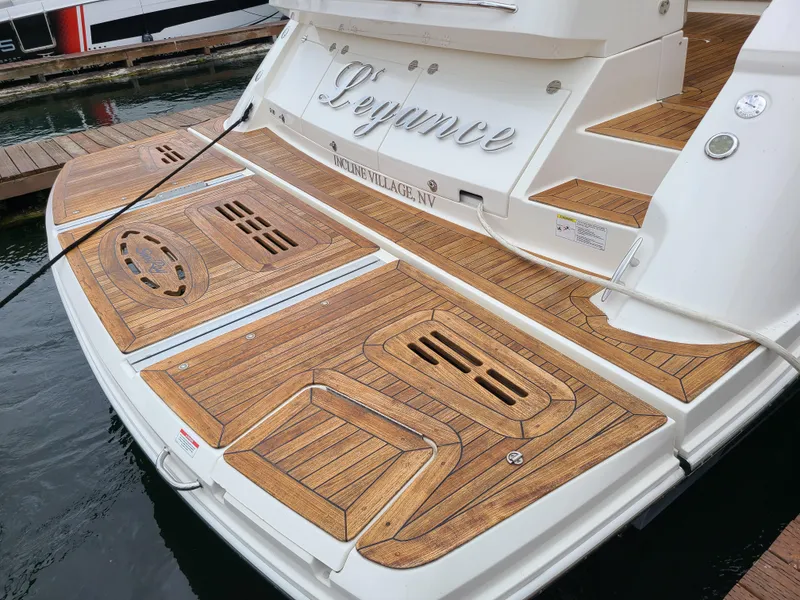 Slide: The Image of 2014 Sea Ray 510 Sundancer yacht with teak swim platform at dock. - 3