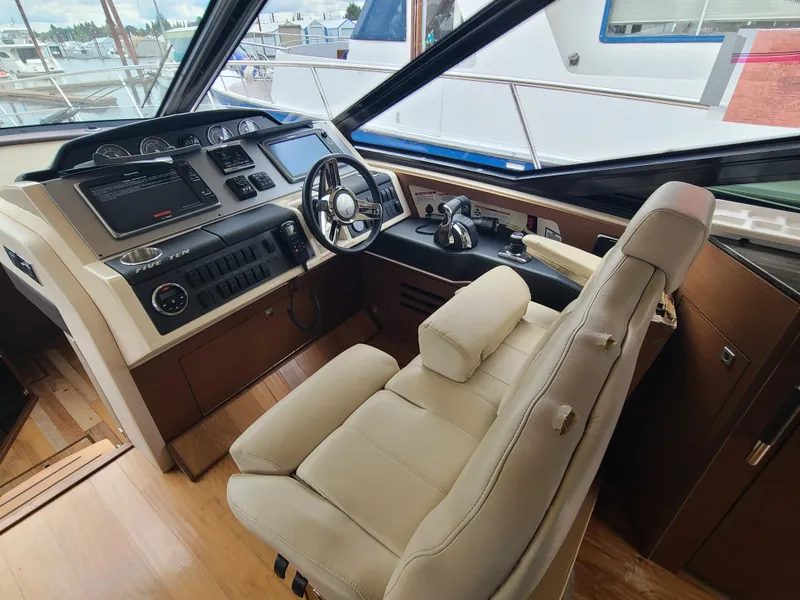 Slide: The Image of 2014 Sea Ray 510 Sundancer helm with leather seat and modern controls. - 6