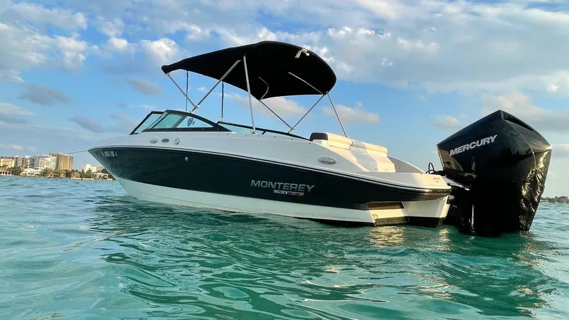 The Image of 2021 Monterey M225 boat on water with Mercury engine, under a clear sky. - 0
