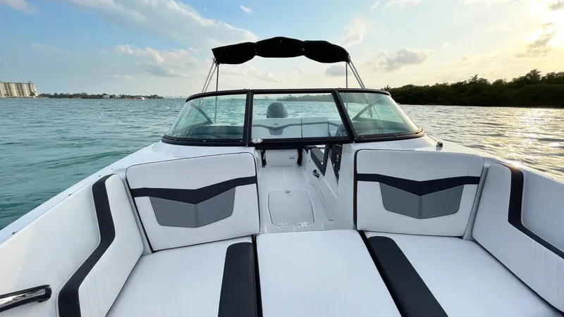 Slide: The Image of 2021 Monterey M225 boat interior with sleek seating on calm water. - 10
