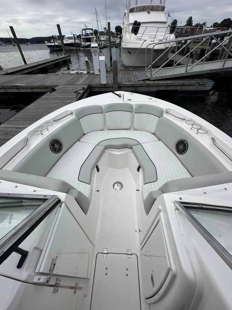 Slide: The Image of 2020 Sea Fox 226 Traveler boat interior at dock, featuring spacious seating and cup holders. - 12