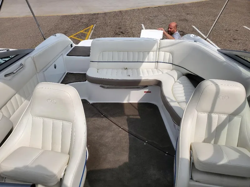 Slide: The Image of 2007 Cobalt 240 boat interior with white leather seating and carpeted floor. - 12