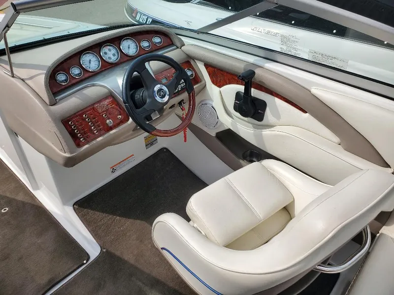 Slide: The Image of Interior of a 2007 Cobalt 240 boat featuring a sleek dashboard and comfortable seating. - 9
