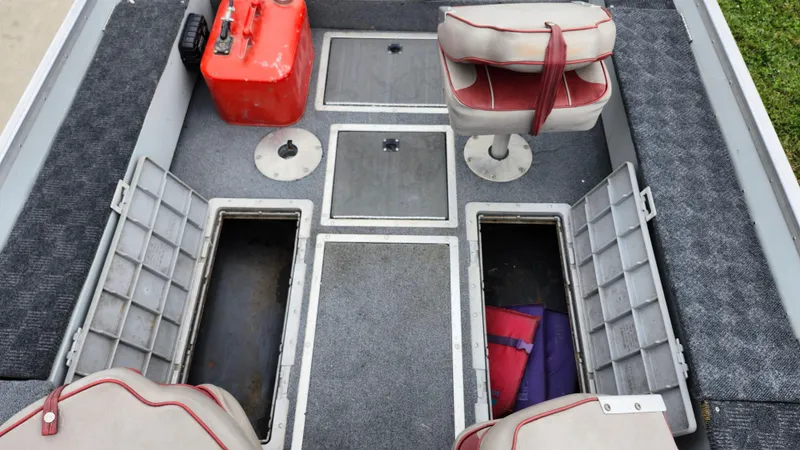 Slide: The Image of 1995 MirroCraft GUIDE IMPACT 16 V boat interior with storage compartments and seating. - 16