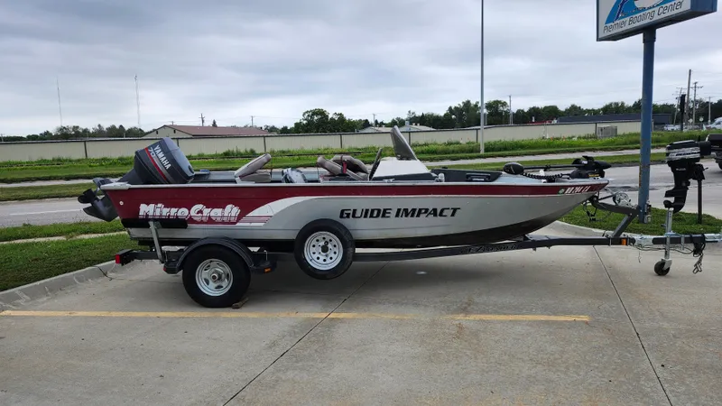 Slide: The Image of 1995 MirroCraft GUIDE IMPACT 16 V boat on trailer, parked outdoors. - 2