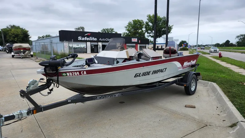 Slide: The Image of 1995 MirroCraft GUIDE IMPACT 16 V boat on trailer, parked near Safelite AutoGlass. - 3