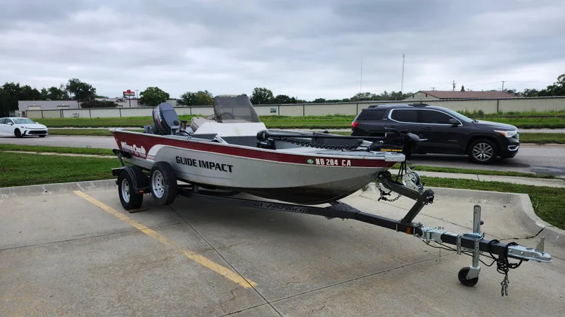 Slide: The Image of 1995 MirroCraft GUIDE IMPACT 16 V boat on trailer in parking lot. - 5