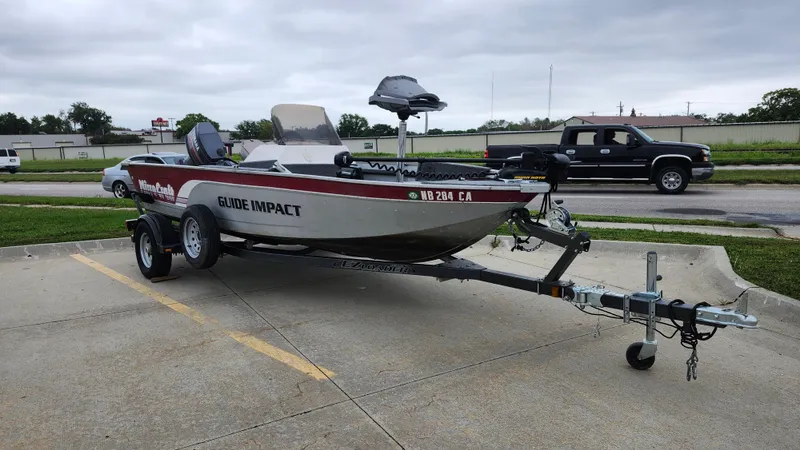 Slide: The Image of 1995 MirroCraft GUIDE IMPACT 16 V boat on trailer in parking lot. - 6
