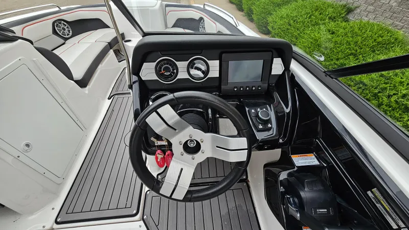 Slide: The Image of 2018 Yamaha Boats 212 X dashboard with steering wheel and controls. - 11