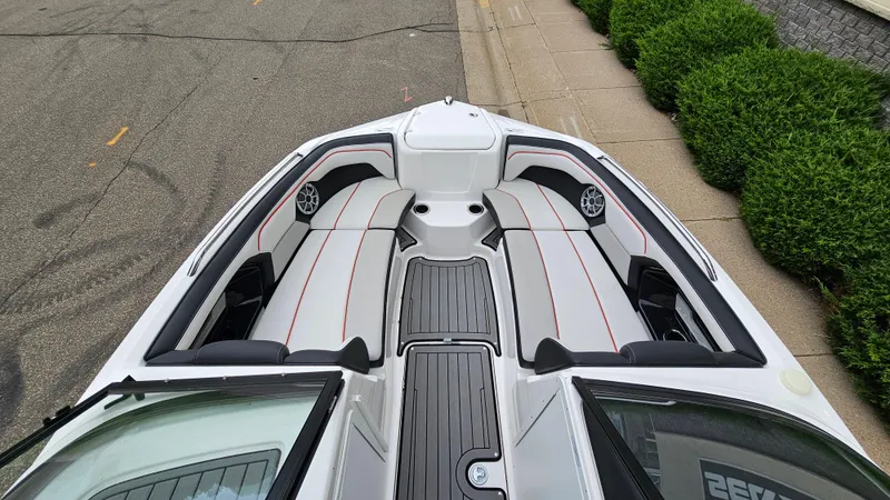 Slide: The Image of 2018 Yamaha Boats 212 X interior, featuring sleek seating and modern design. - 13