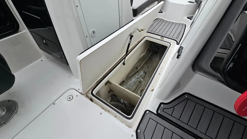 Slide: The Image of Open storage compartment on 2018 Yamaha Boats 212 X deck. - 21