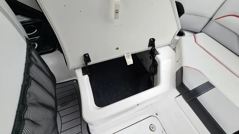 Slide: The Image of Open storage compartment in 2018 Yamaha Boats 212 X interior. - 22