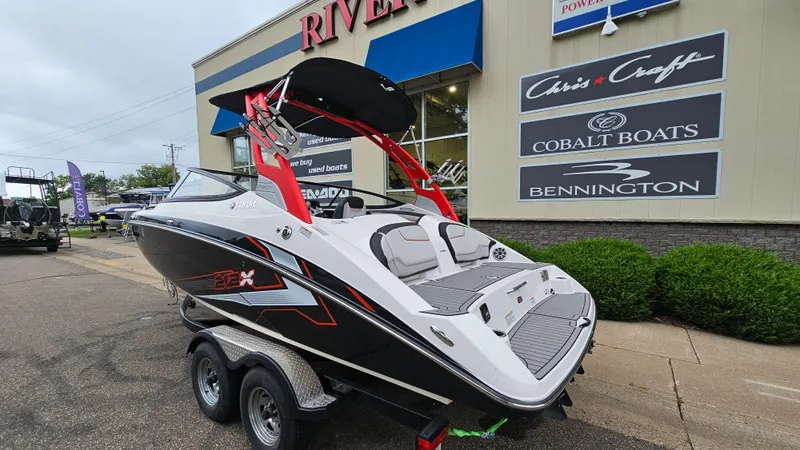 Slide: The Image of 2018 Yamaha Boats 212 X on trailer outside dealership. - 3
