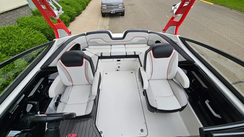 Slide: The Image of 2018 Yamaha Boats 212 X interior with red accents and seating arrangement. - 6