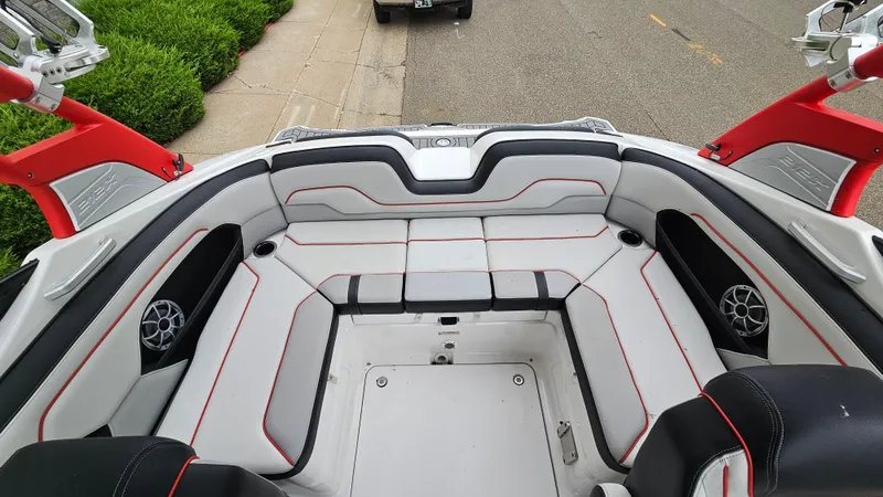 Slide: The Image of 2018 Yamaha Boats 212 X interior with red-accented seating and speakers. - 7