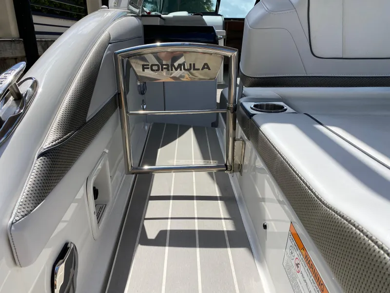 Slide: The Image of 2021 Formula 310 Bowrider I/O interior with sleek seating and stainless steel accents. - 12