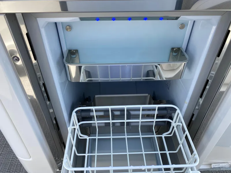 Slide: The Image of 2021 Formula 310 Bowrider I/O boat refrigerator with open shelves and blue LED lights. - 22