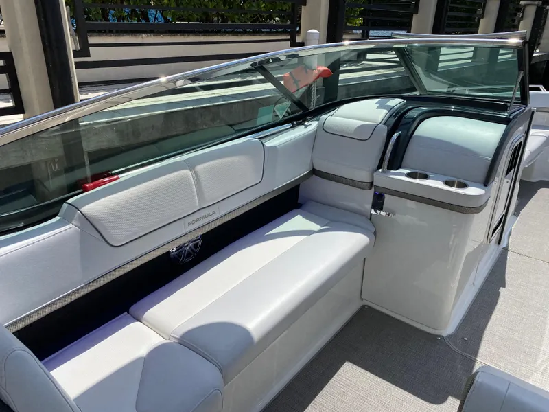 Slide: The Image of 2021 Formula 310 Bowrider I/O interior with sleek white seating and modern design. - 24