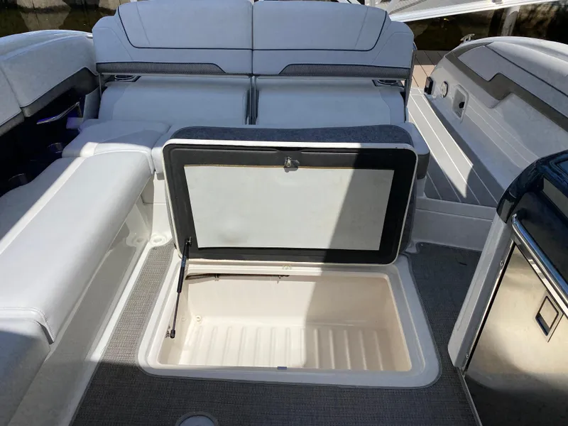 Slide: The Image of Open storage compartment on 2021 Formula 310 Bowrider I/O boat interior. - 25