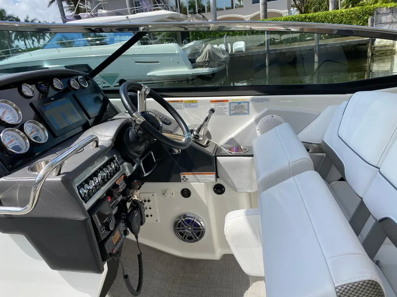 Slide: The Image of 2021 Formula 310 Bowrider I/O cockpit with modern controls and white seating. - 26