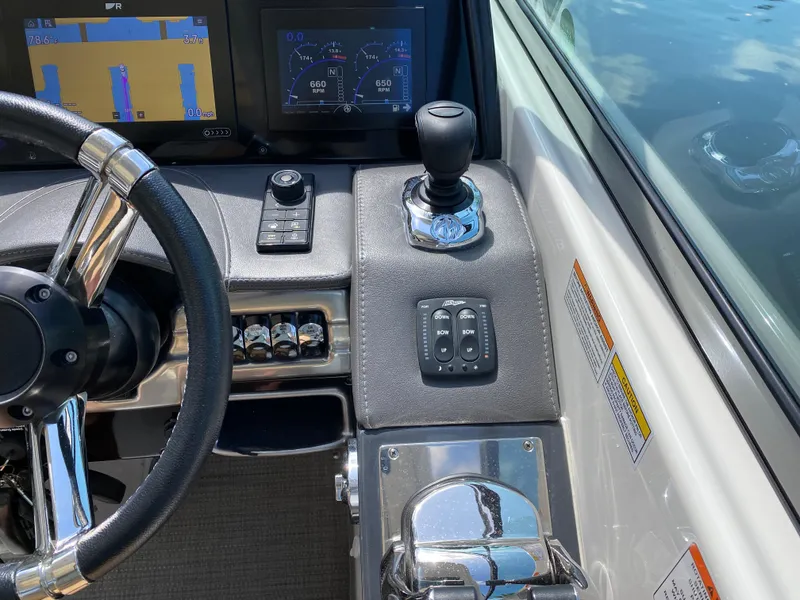 Slide: The Image of 2021 Formula 310 Bowrider I/O dashboard with steering wheel and control panel. - 27