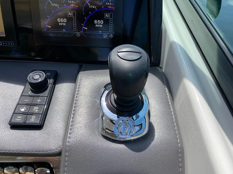 Slide: The Image of 2021 Formula 310 Bowrider I/O dashboard with joystick control and digital display. - 28