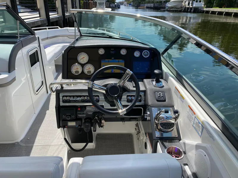 Slide: The Image of 2021 Formula 310 Bowrider I/O dashboard with steering wheel and control panel. - 29