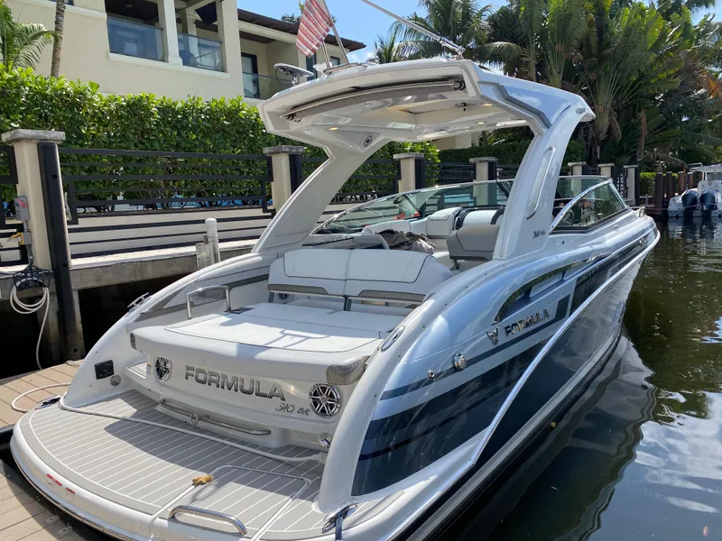 Slide: The Image of 2021 Formula 310 Bowrider I/O docked by a waterfront home. - 3