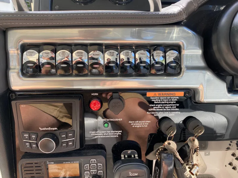 Slide: The Image of Control panel of 2021 Formula 310 Bowrider I/O with switches, keys, and navigation equipment. - 30