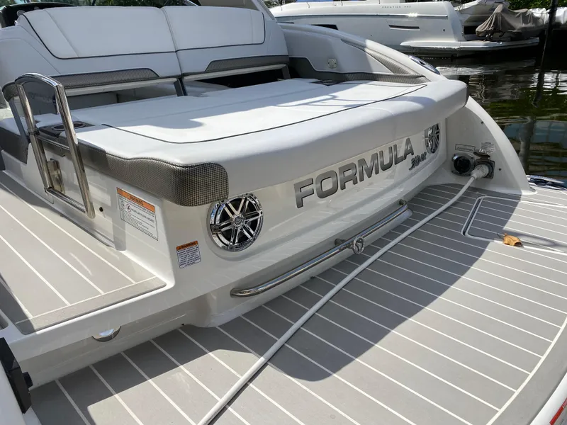 Slide: The Image of 2021 Formula 310 Bowrider I/O boat, rear view, docked on water. - 7