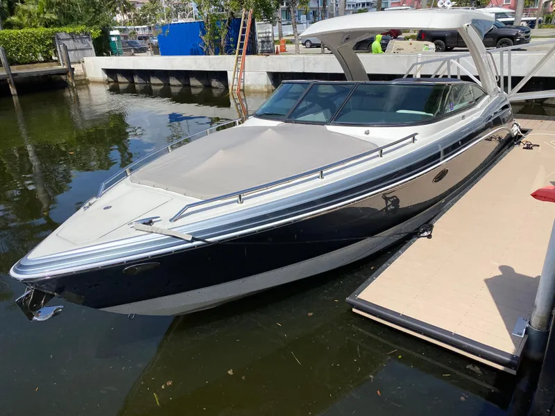 Slide: The Image of 2021 Formula 310 Bowrider I/O docked in a marina, sleek design, sunny day. - 9
