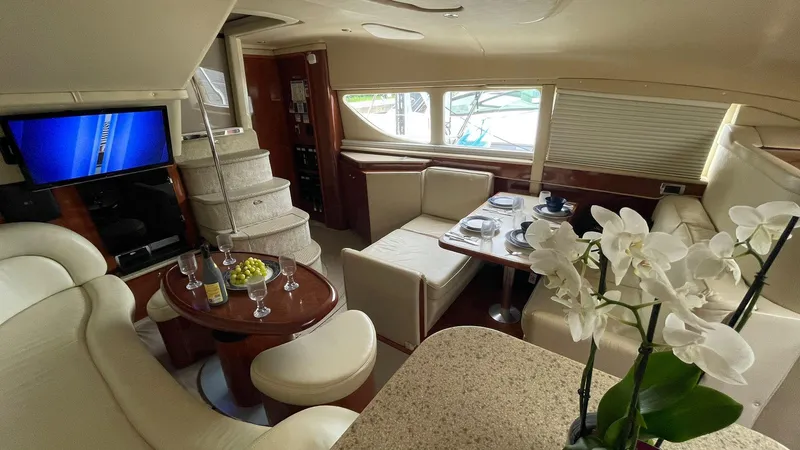 Slide: The Image of Luxurious interior of 2003 Sea Ray 390 Motor Yacht with elegant seating and dining area. - 10