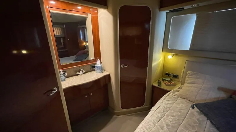 Slide: The Image of Cozy bedroom interior of 2003 Sea Ray 390 Motor Yacht with wood accents and soft lighting. - 3