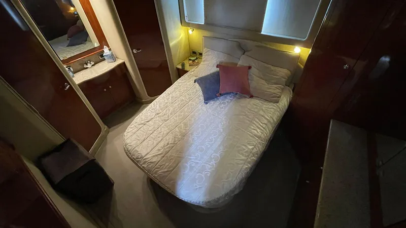 Slide: The Image of Cozy bedroom in 2003 Sea Ray 390 Motor Yacht with double bed and soft lighting. - 5