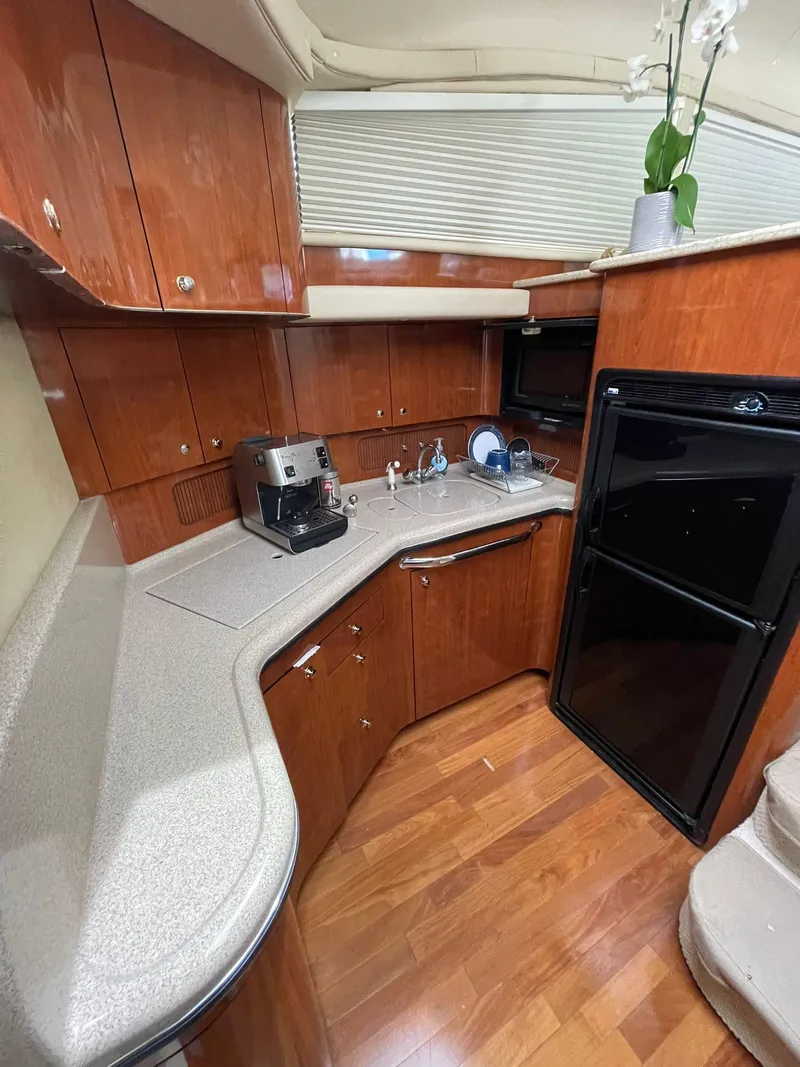 Slide: The Image of 2003 Sea Ray 390 Motor Yacht kitchen with wood cabinets and modern appliances. - 7