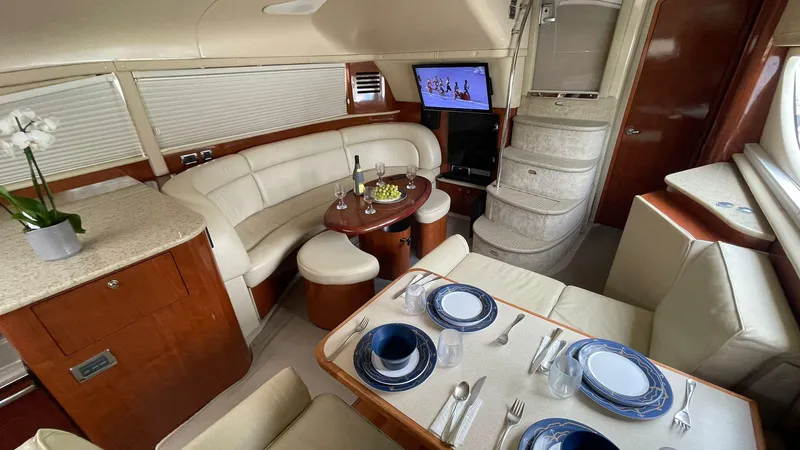 Slide: The Image of Luxurious interior of 2003 Sea Ray 390 Motor Yacht with elegant dining and seating area. - 9