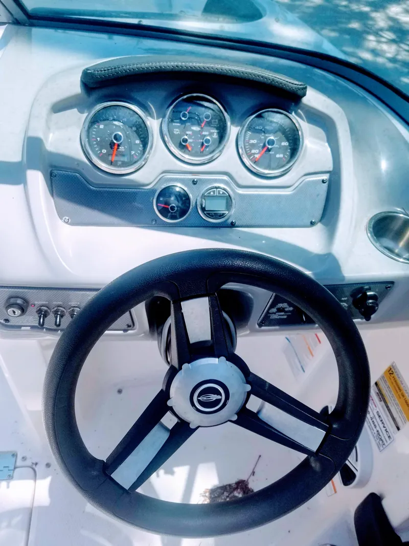 Slide: The Image of 2016 Chaparral 21 H2O Sport dashboard with steering wheel and gauges. - 11