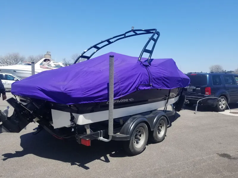 Slide: The Image of 2016 Chaparral 21 H2O Sport boat with purple cover on trailer. - 18