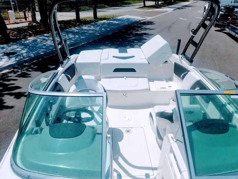 Slide: The Image of 2016 Chaparral 21 H2O Sport boat interior with open seating and windshield. - 21