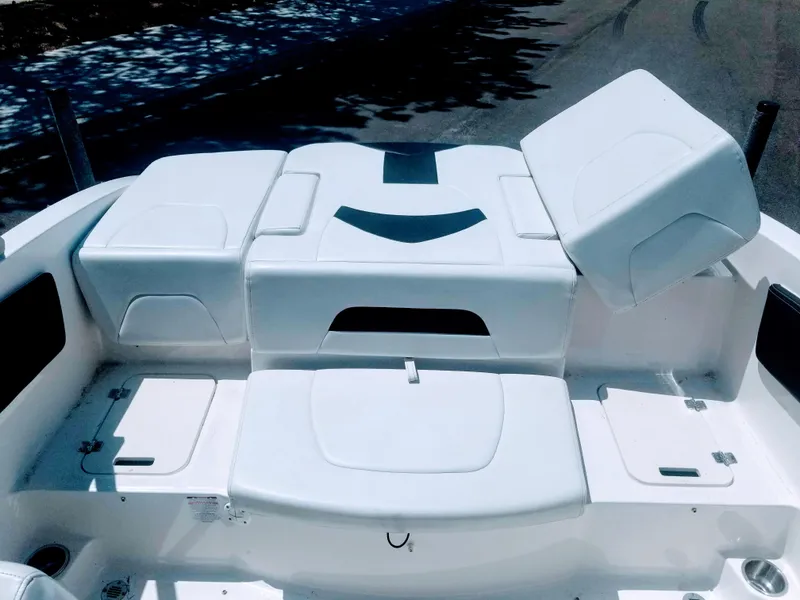 Slide: The Image of 2016 Chaparral 21 H2O Sport boat interior seating area, white upholstery. - 27