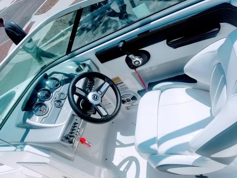 Slide: The Image of 2016 Chaparral 21 H2O Sport boat interior with steering wheel and dashboard. - 3