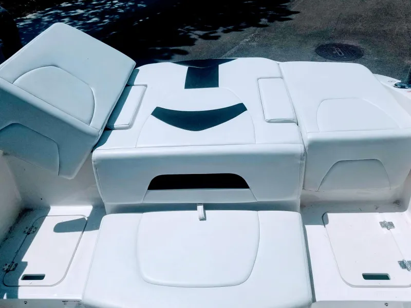 Slide: The Image of 2016 Chaparral 21 H2O Sport boat seating area with white upholstery. - 8