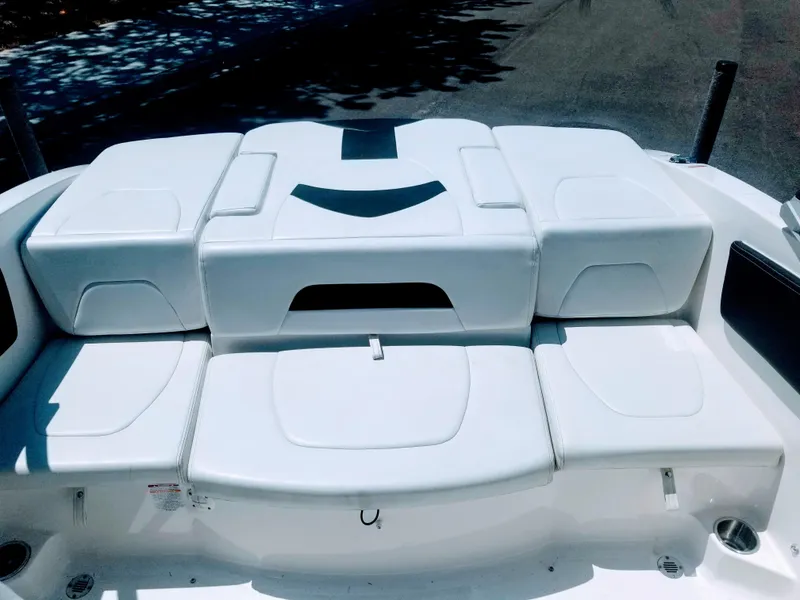 Slide: The Image of 2016 Chaparral 21 H2O Sport boat with white cushioned seating. - 9