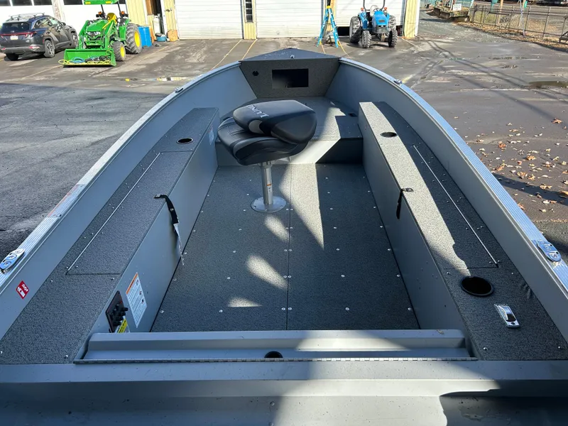 Slide: The Image of 2025 Lund Fury 1400 Tiller boat interior with seating and storage compartments. - 4