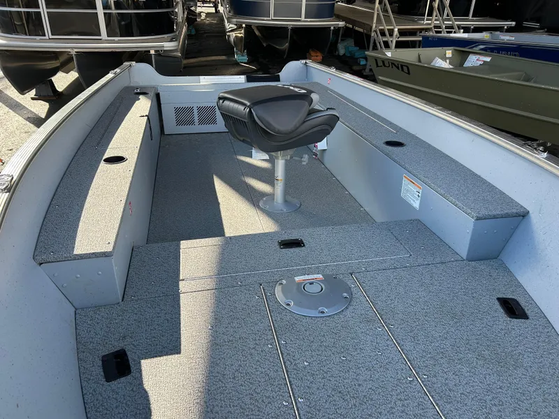 Slide: The Image of 2025 Lund Fury 1400 Tiller boat interior with seating and storage compartments. - 5