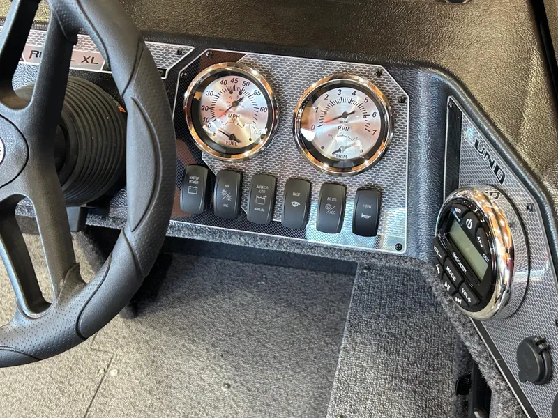 Slide: The Image of 2025 Lund Rebel XL 1650 XL SS dashboard with gauges and controls. - 15